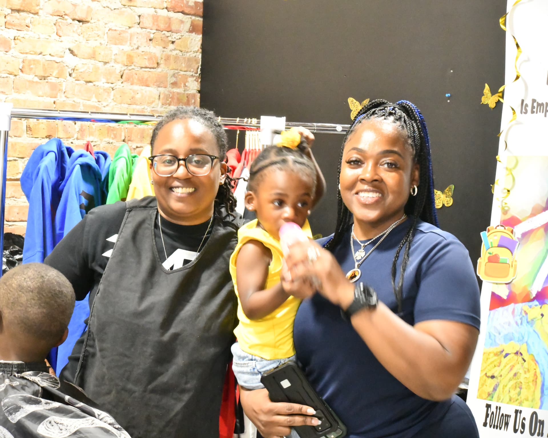 Volunteers and a family posing together at a community event